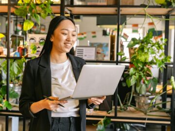 woman working on laptop in office full of plants