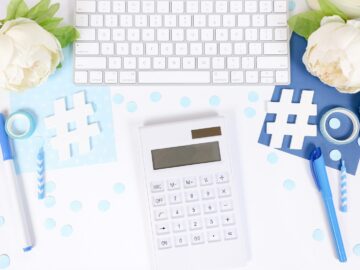 white and black calculator on white and blue textile